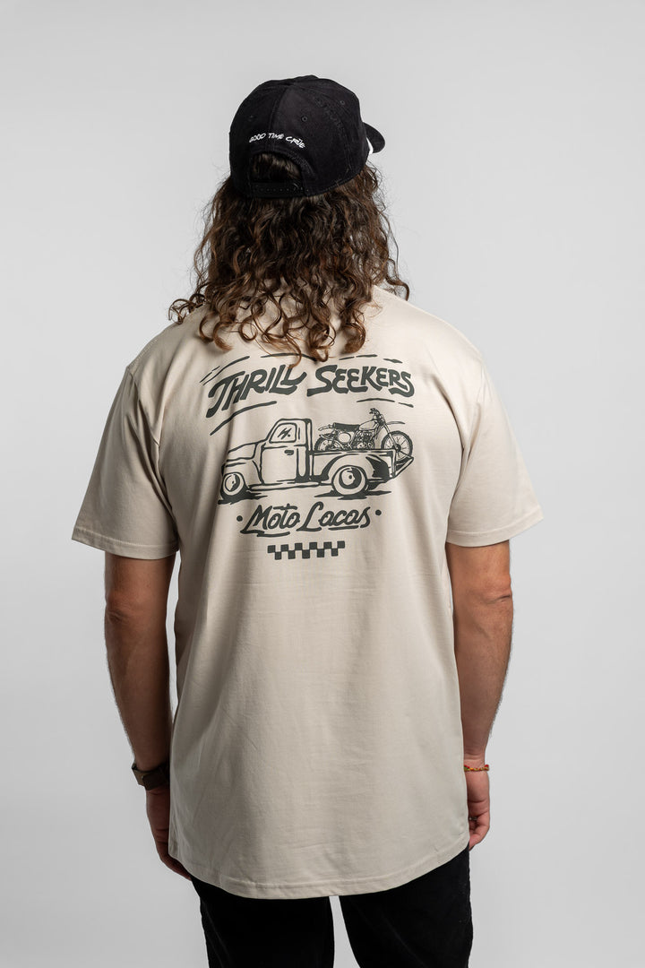 Person wearing bone tee with 'Thrill Seekers' moto locos logo in green
