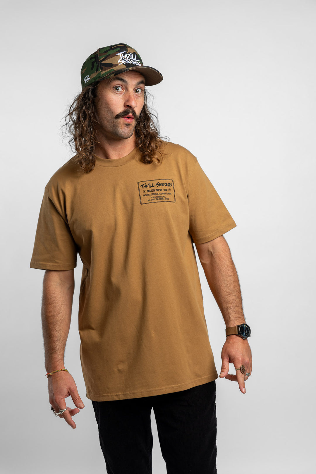 Person wearing a camel tee with a 'Thrill Seekers' workman logo