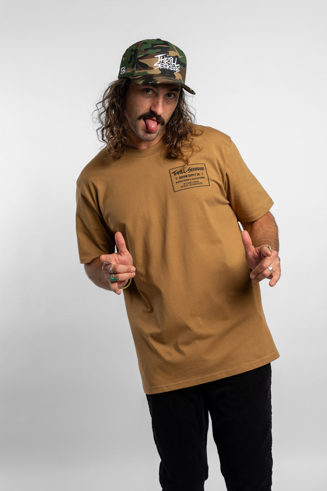Person wearing a camel tee with a 'Thrill Seekers' workman logo