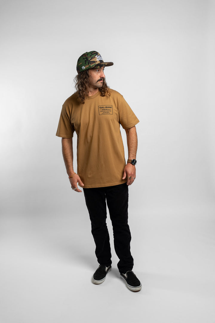 Person wearing a camel tee with a 'Thrill Seekers' workman logo