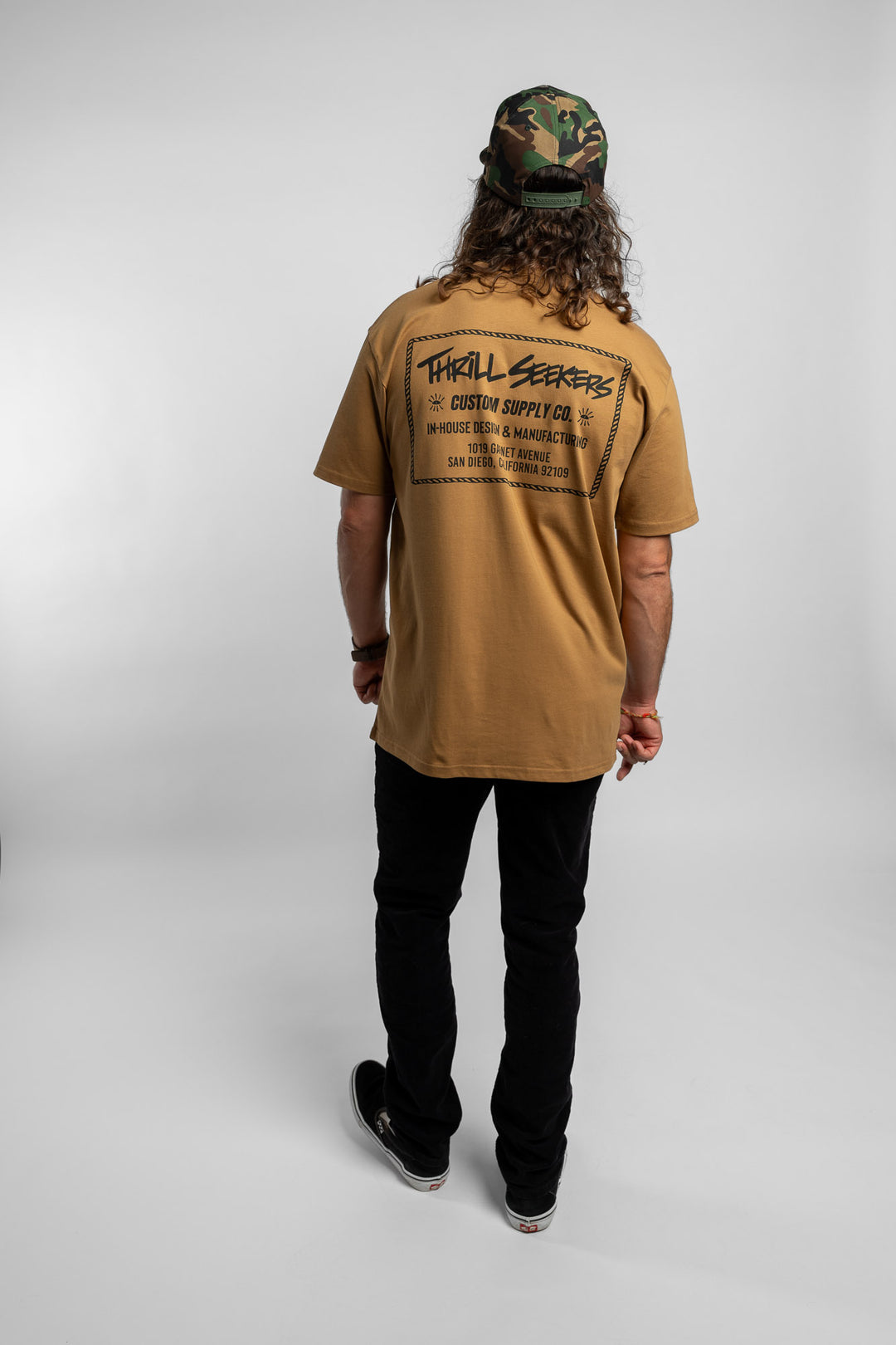 Person wearing a camel tee with a 'Thrill Seekers' workman logo