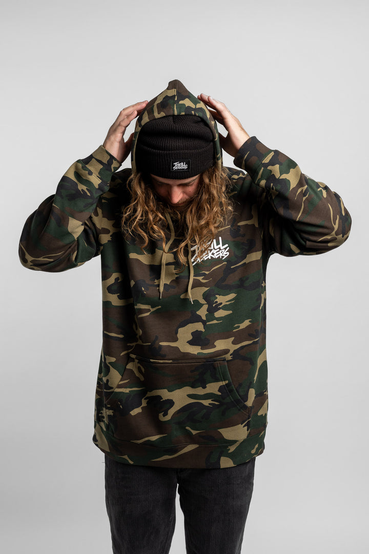 Person wearing camo hoodie with 'Thrill Seekers' logo in white