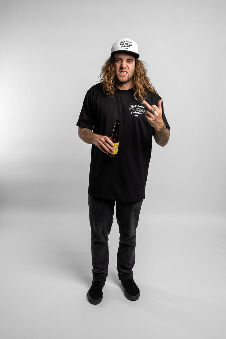 Person wearing black tee with 'Thrill Seekers' shop logo