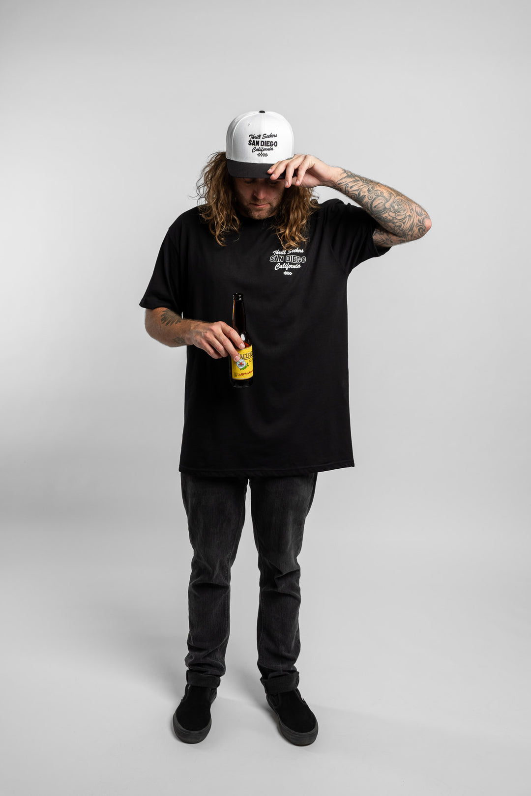 Person wearing black tee with 'Thrill Seekers' shop logo