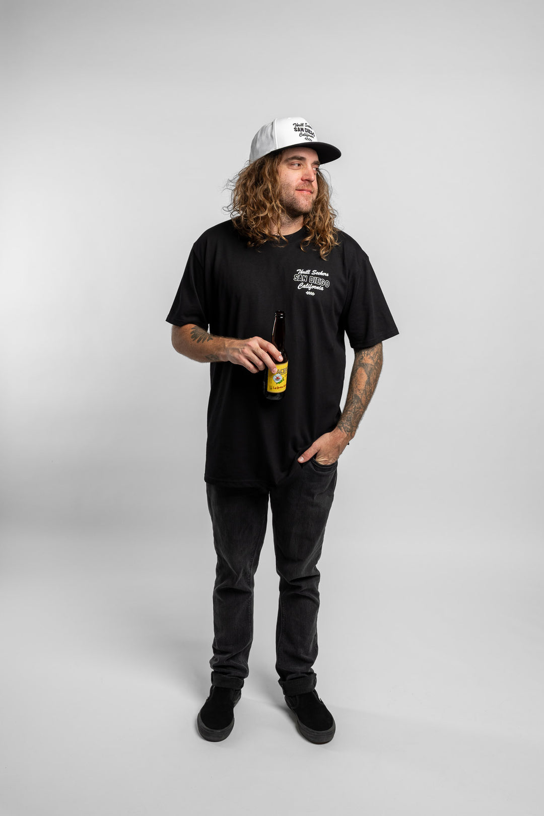 Person wearing black tee with 'Thrill Seekers' shop logo