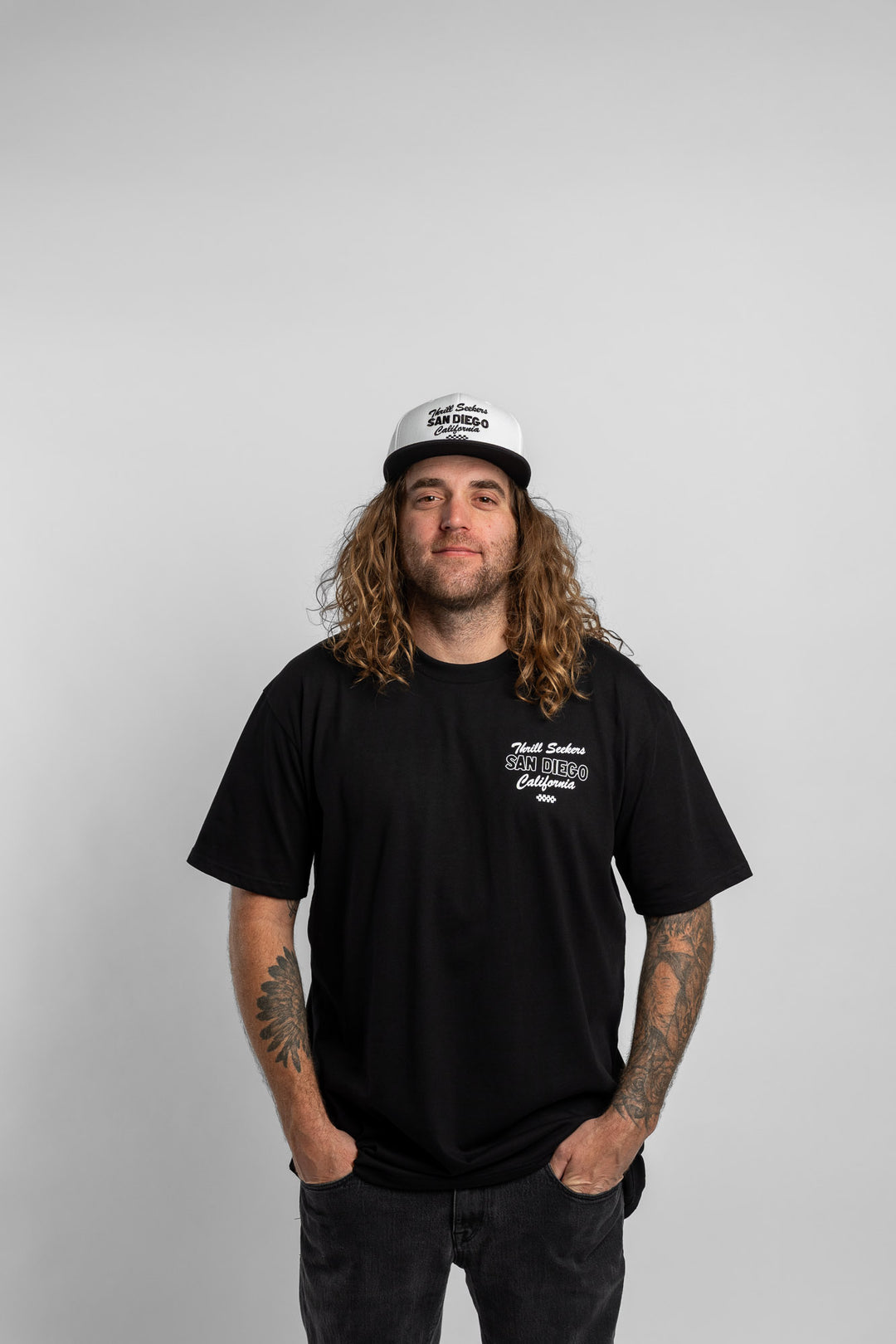 Person wearing black tee with 'Thrill Seekers' shop logo