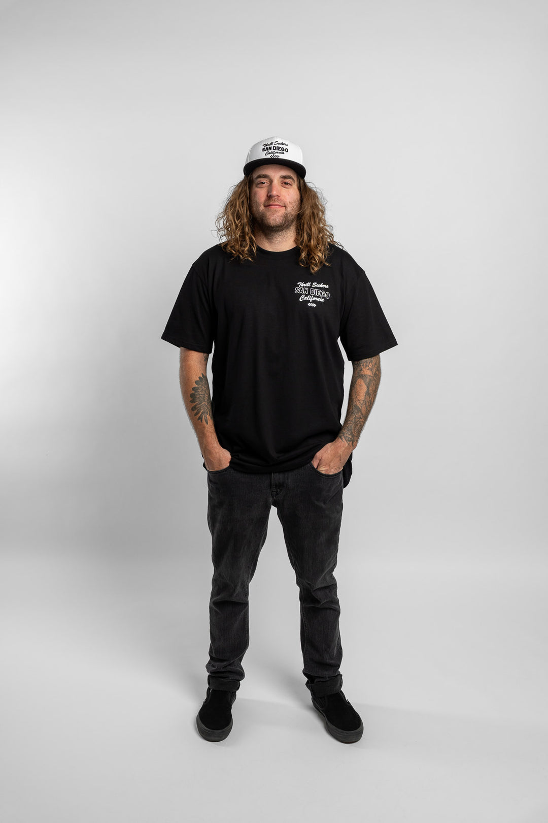 Person wearing black tee with 'Thrill Seekers' shop logo