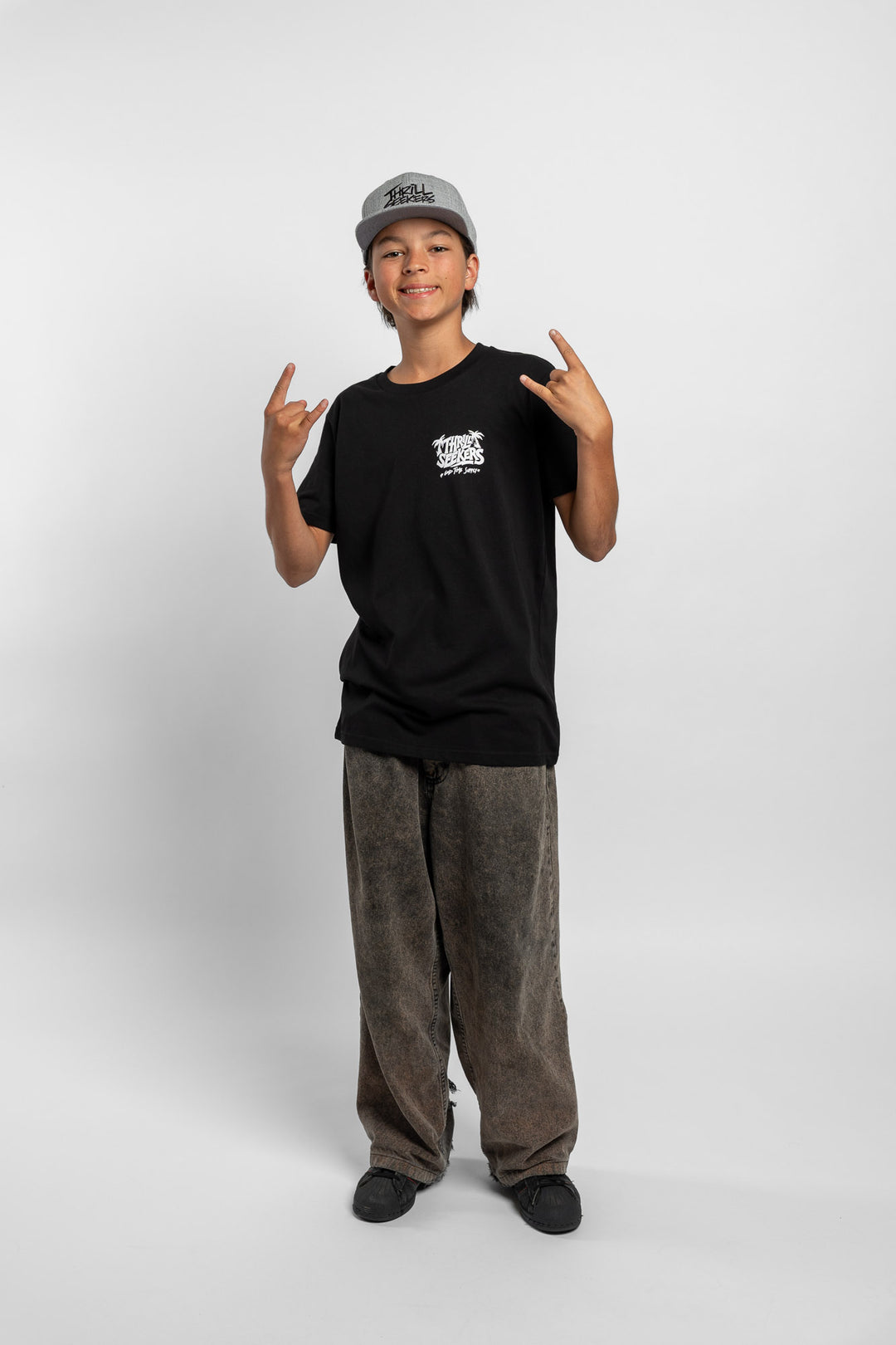 Kid wearing black tee with 'Thrill Seekers' good time supply logo in white