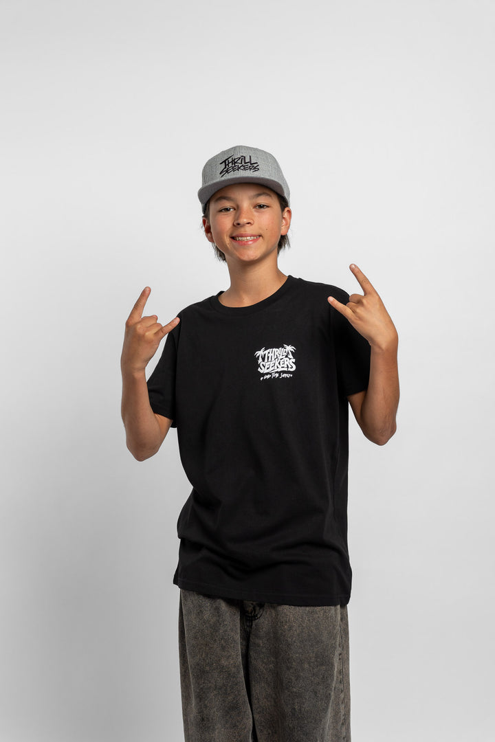 Kid wearing black tee with 'Thrill Seekers' good time supply logo in white