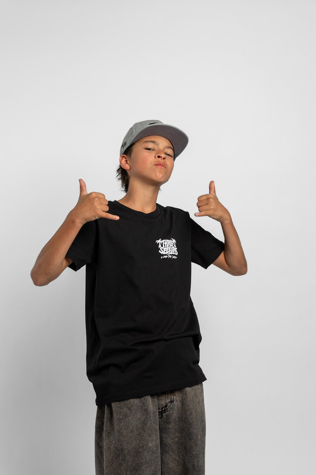 Kid wearing black tee with 'Thrill Seekers' good time supply logo in white