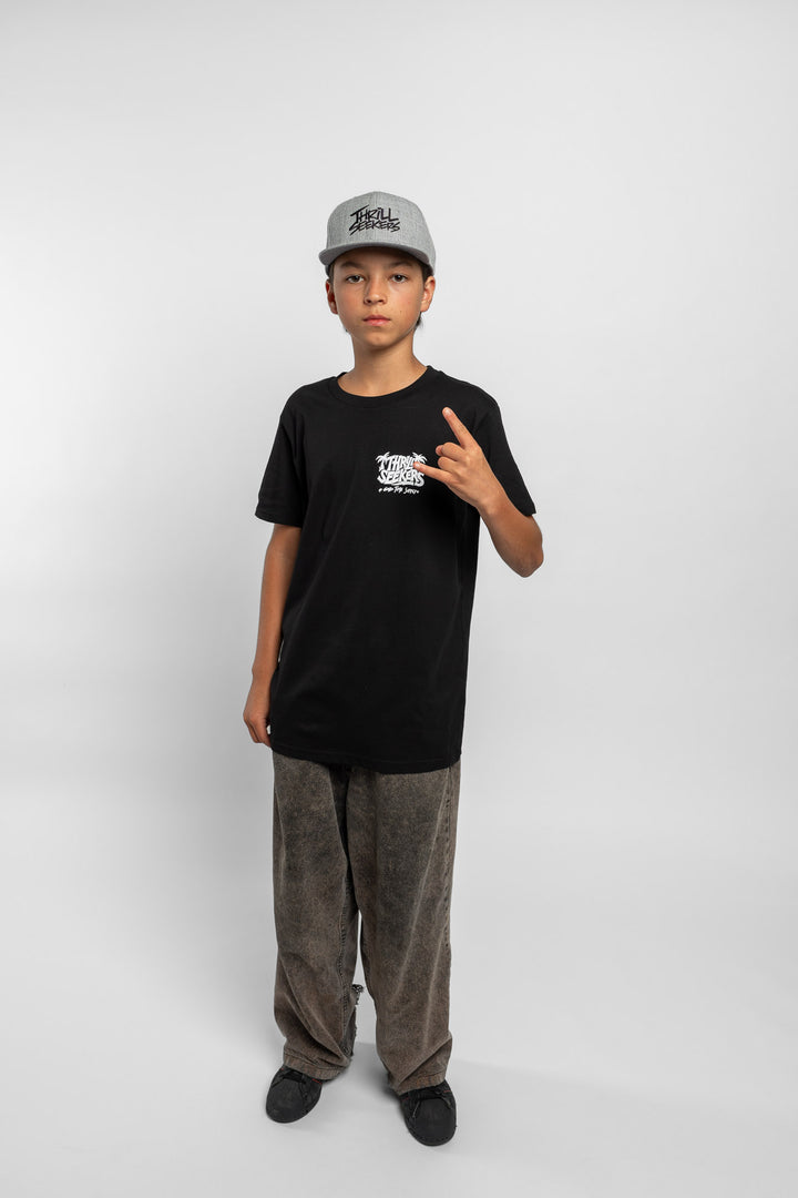 Kid wearing black tee with 'Thrill Seekers' good time supply logo in white