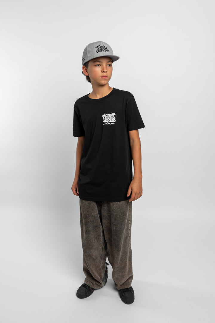 Kid wearing black tee with 'Thrill Seekers' good time supply logo in white