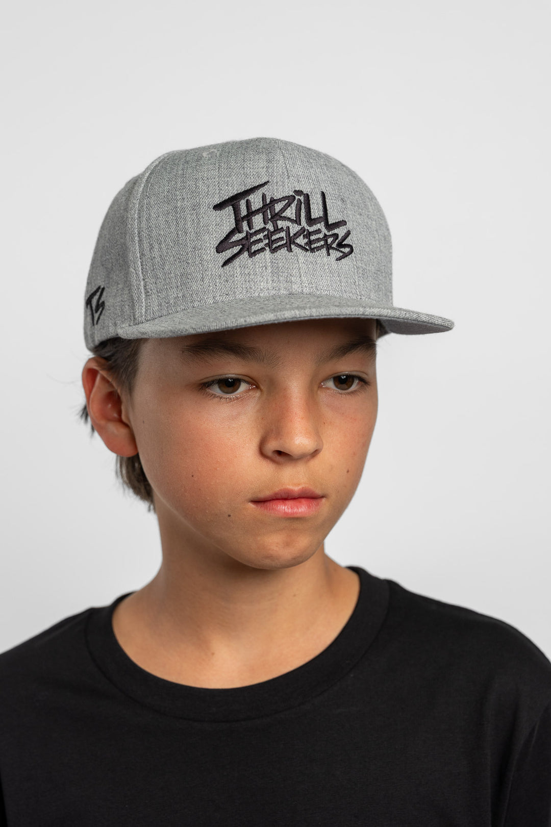 Grey cap with black 'Thrill Seekers' logo on a white background