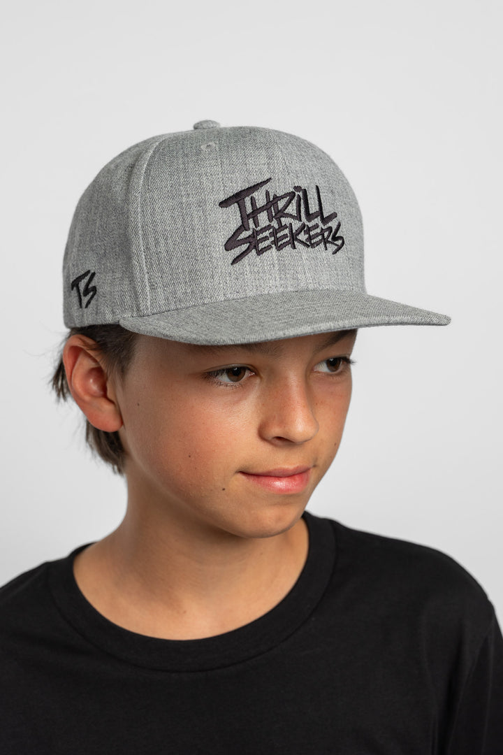 Grey cap with black 'Thrill Seekers' logo on a white background