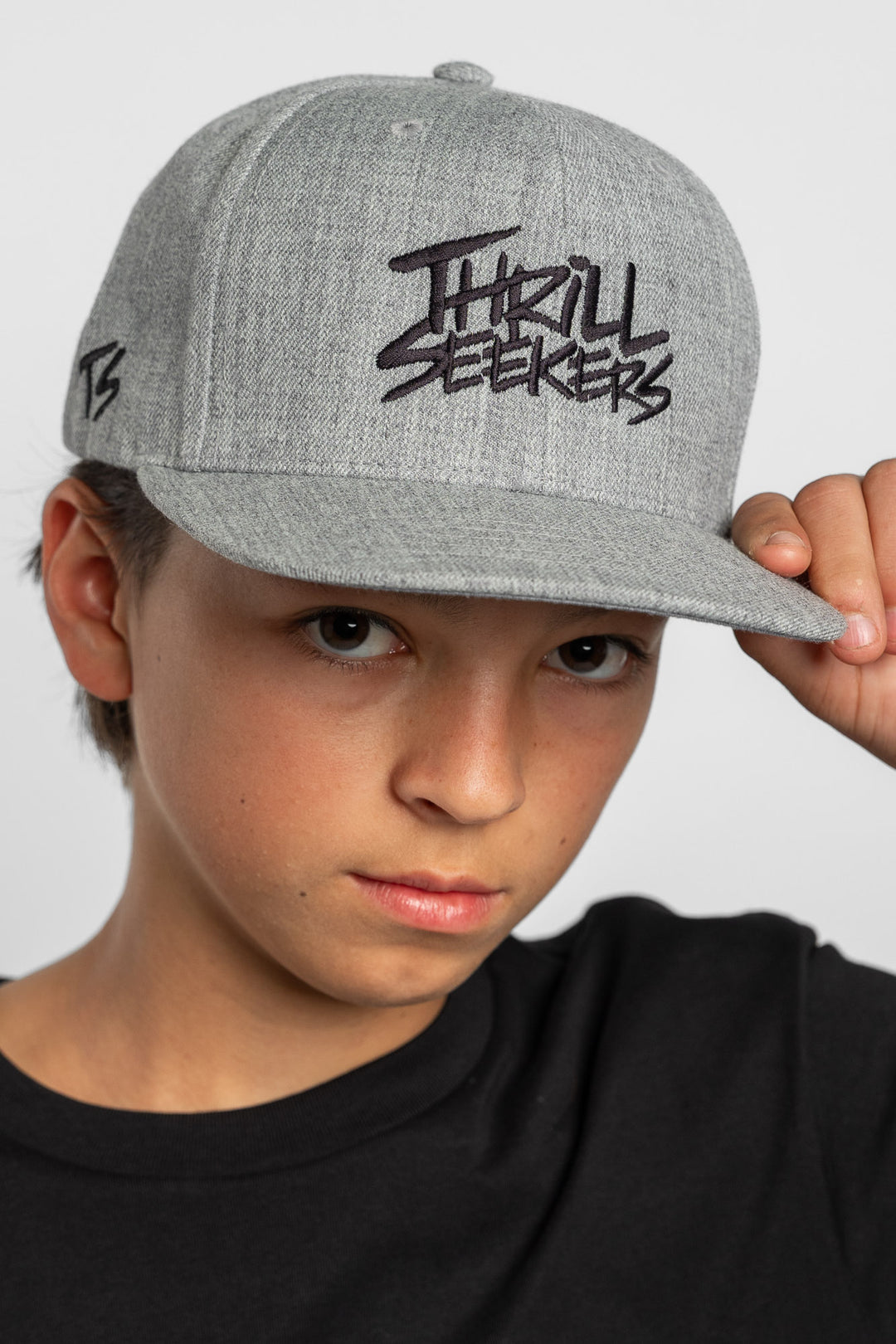 Grey cap with black 'Thrill Seekers' logo on a white background
