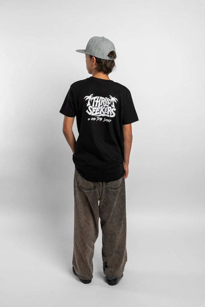 Kid wearing black tee with 'Thrill Seekers' good time supply logo in white