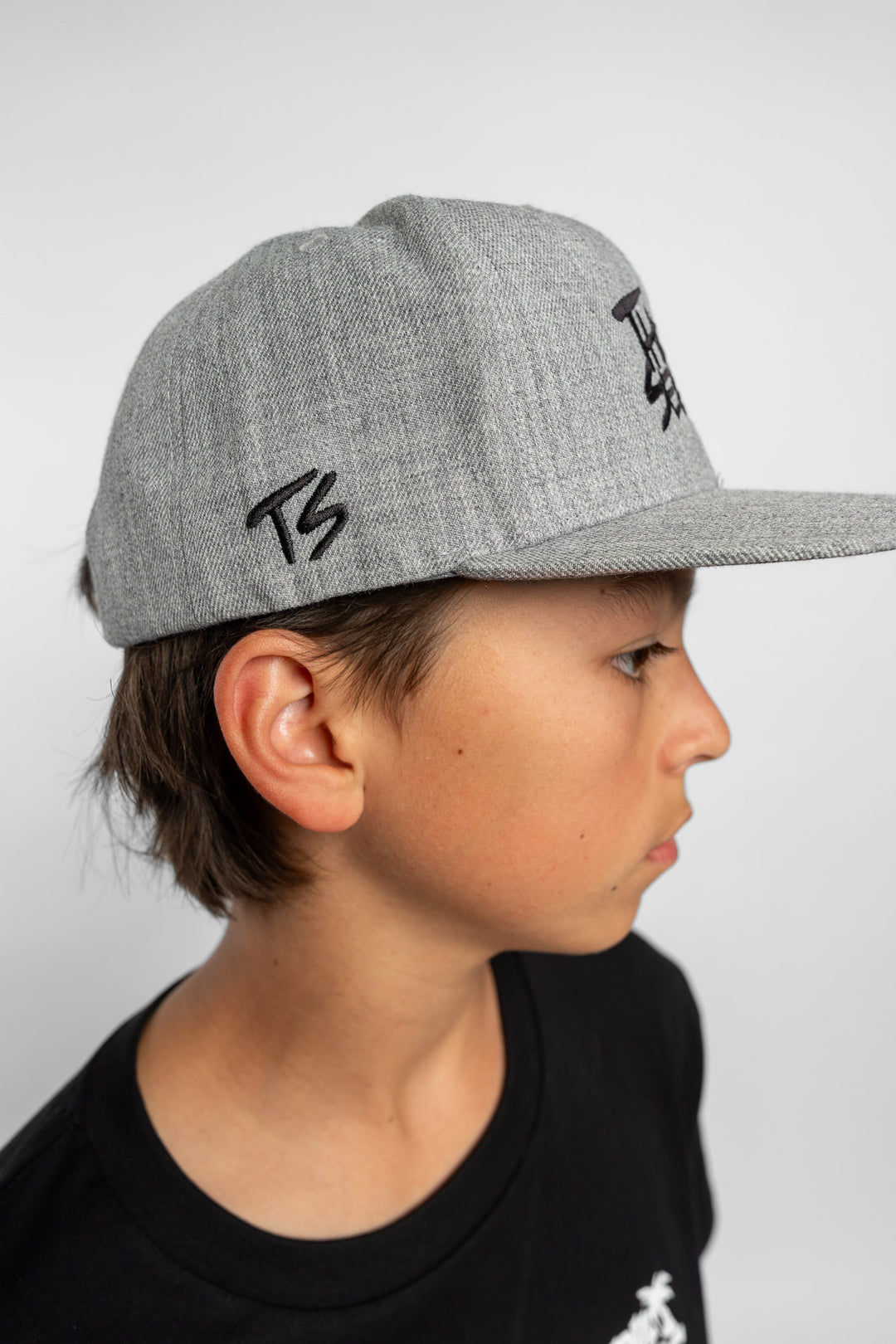 Grey cap with black 'Thrill Seekers' logo on a white background