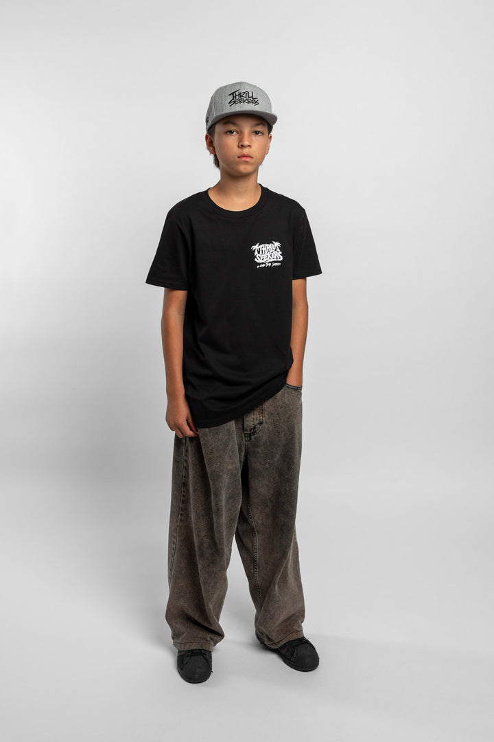 Kid wearing black tee with 'Thrill Seekers' good time supply logo in white