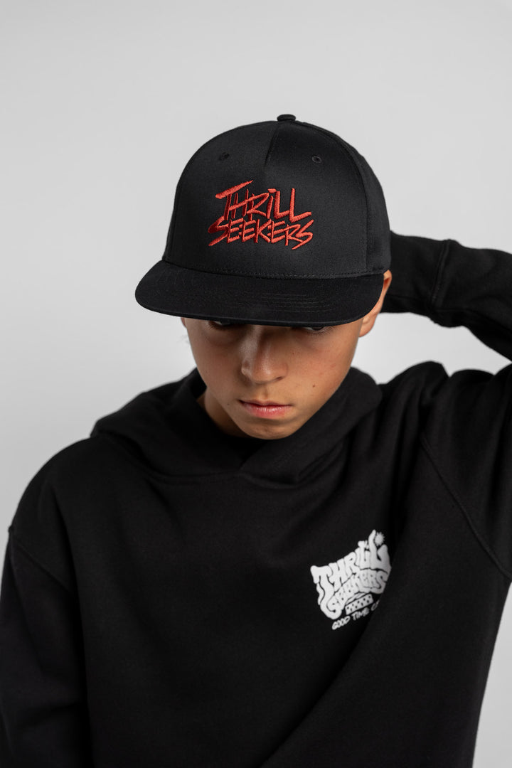 Black cap with cardinal red 'Thrill Seekers' text on a white background