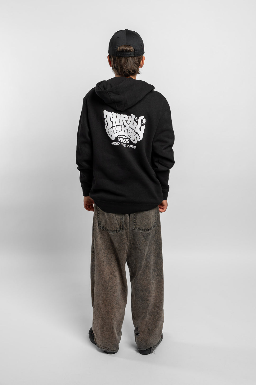 Kid wearing black hoodie with 'Thrill Seekers' smokin' logo in black