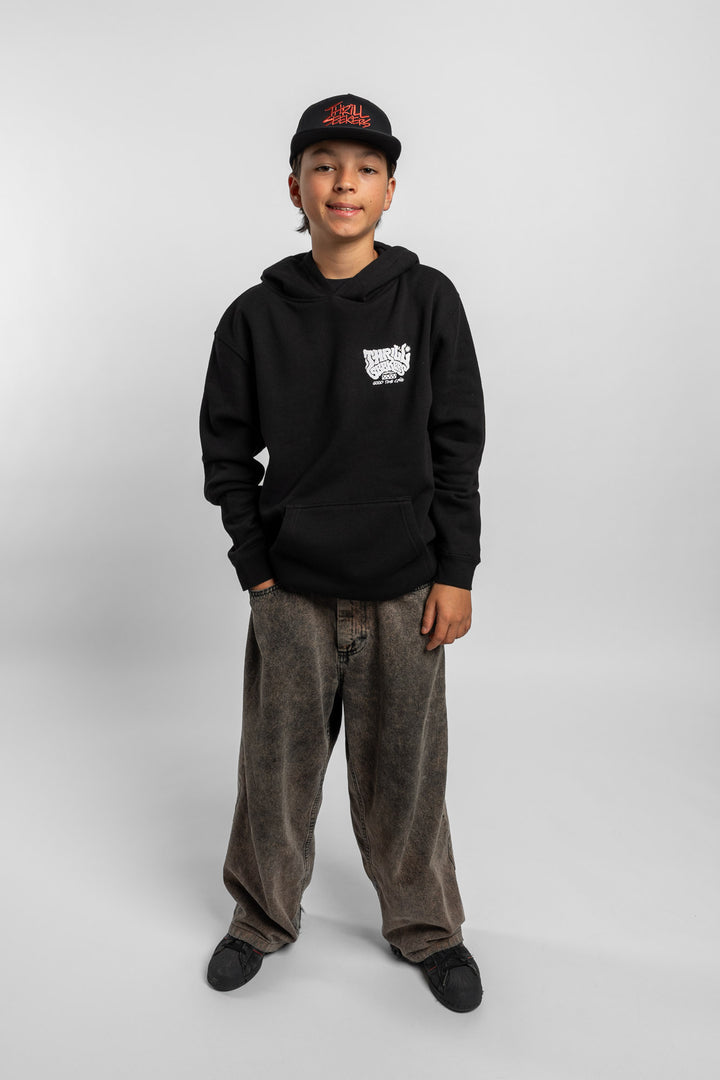 Kid wearing black hoodie with 'Thrill Seekers' smokin' logo in black