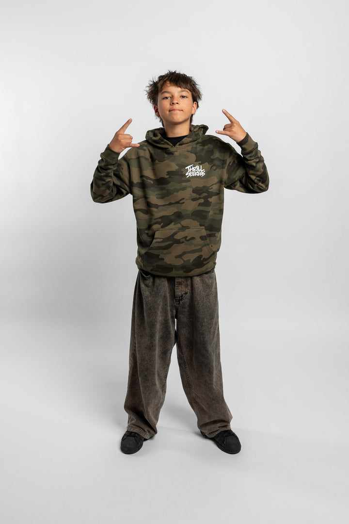 Kid wearing a camo hoodie with 'Thrill Seekers' logo in white