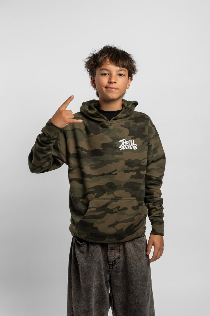 Kid wearing a camo hoodie with 'Thrill Seekers' logo in white