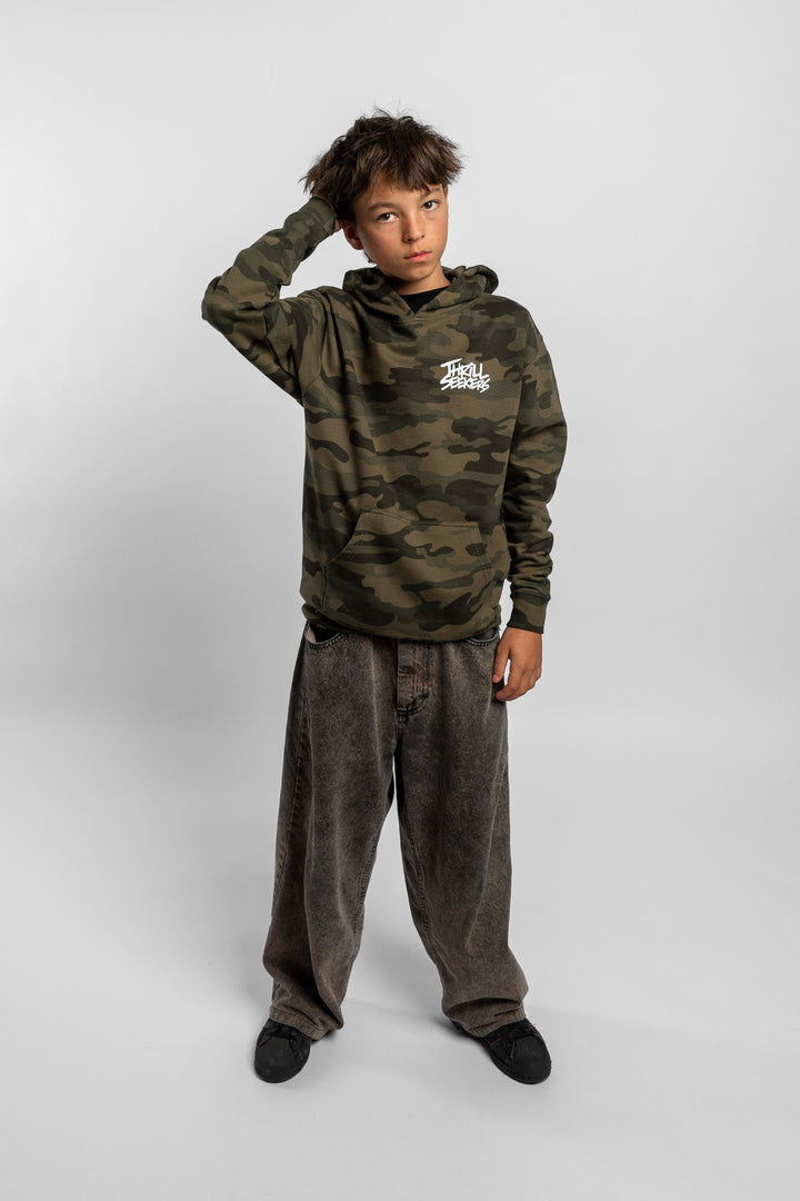 Kid wearing a camo hoodie with 'Thrill Seekers' logo in white