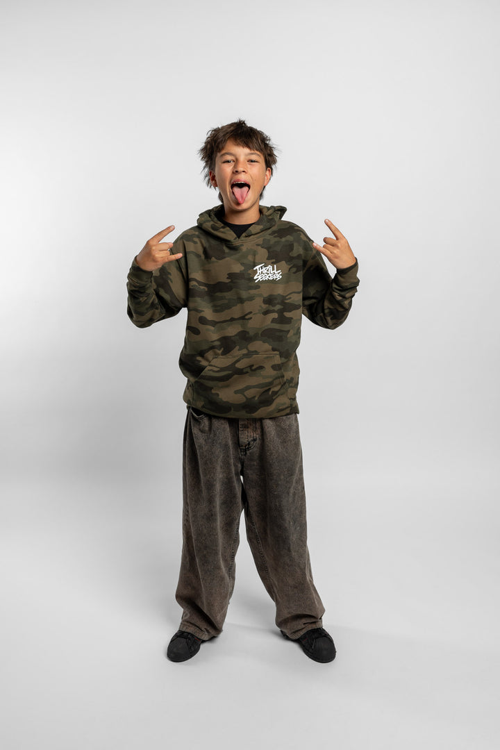 Kid wearing a camo hoodie with 'Thrill Seekers' logo in white