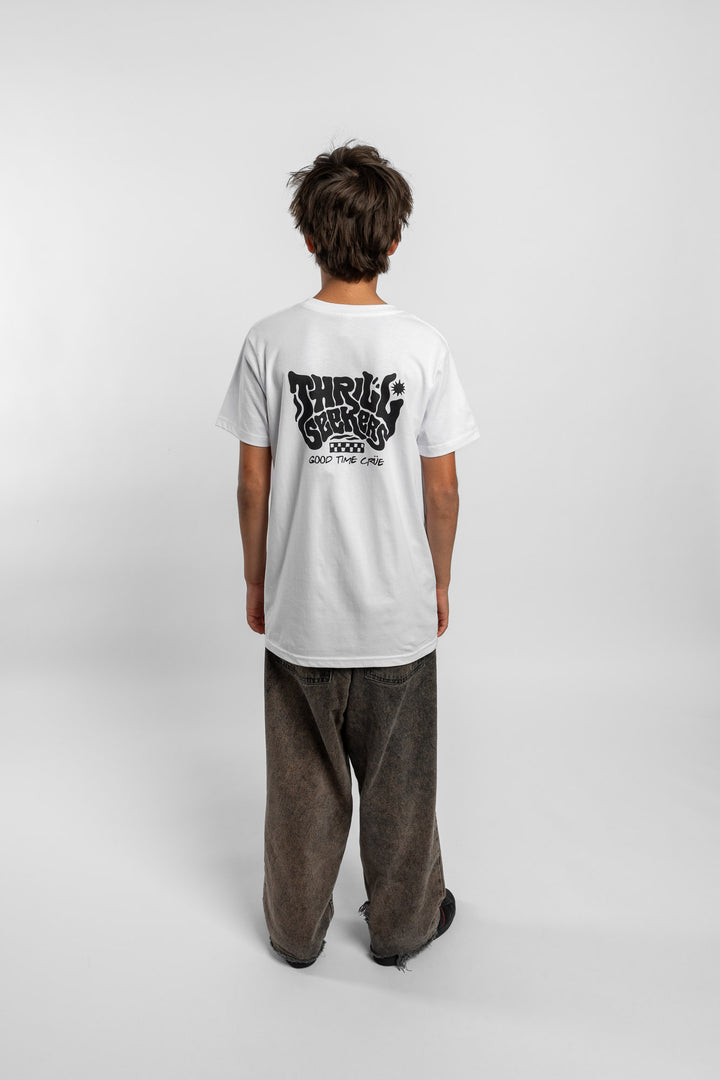 Kid wearing a white tee with 'Thrill Seekers' smokin logo in black
