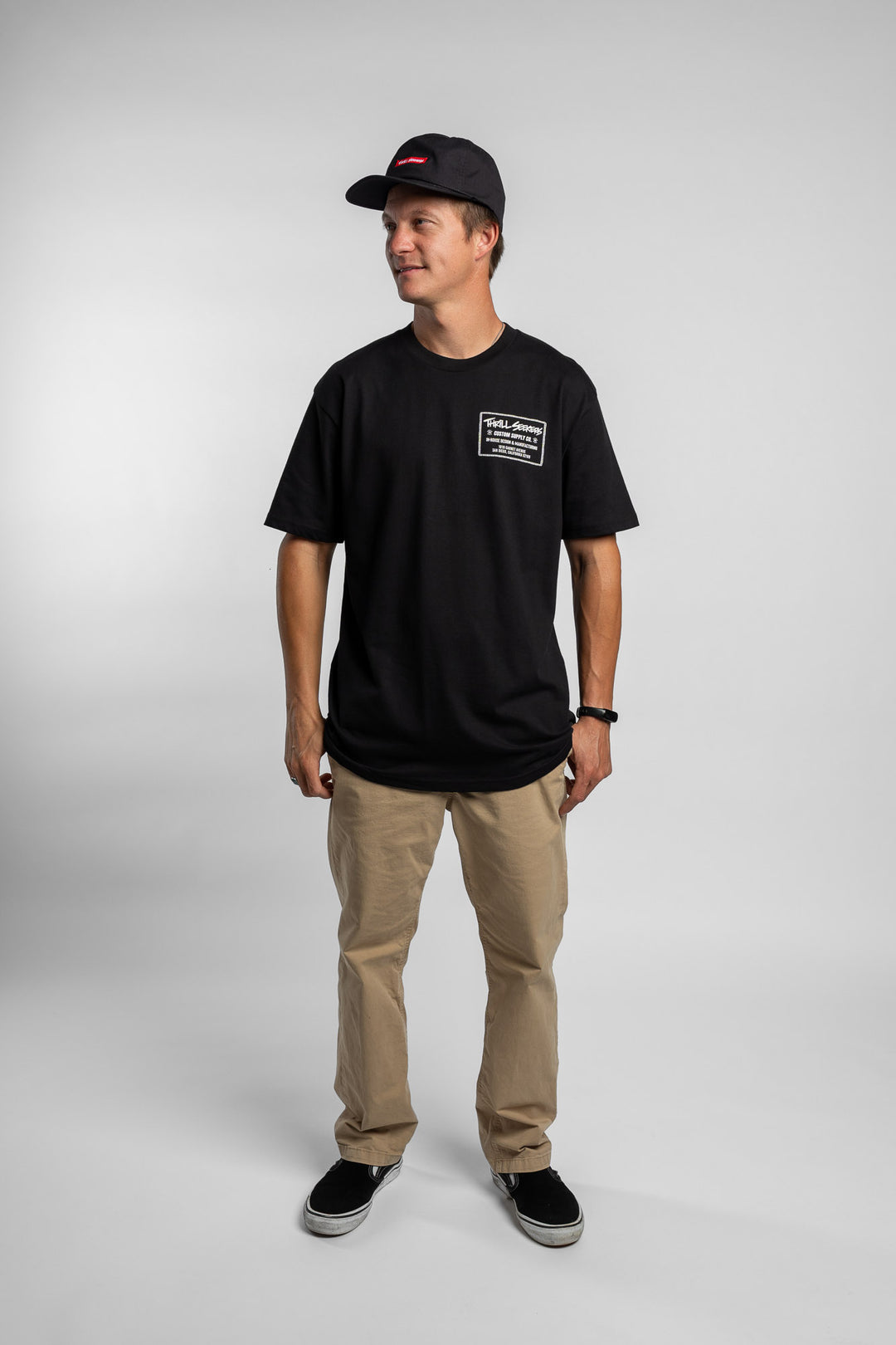 Person wearing black tee with 'Thrill Seekers' workman logo in white