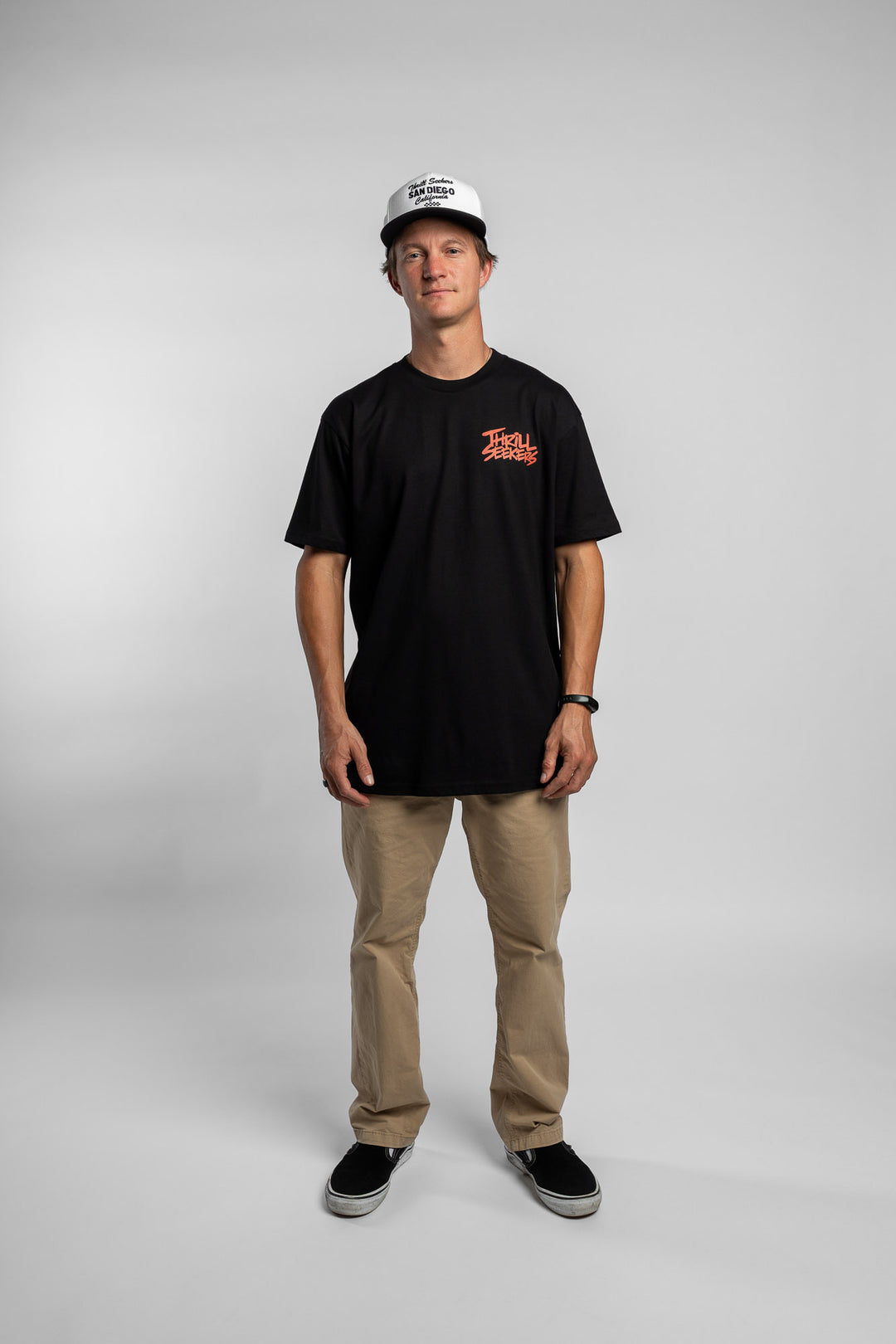 Person wearing a black tee with a 'Thrill Seekers' logo in cardinal red