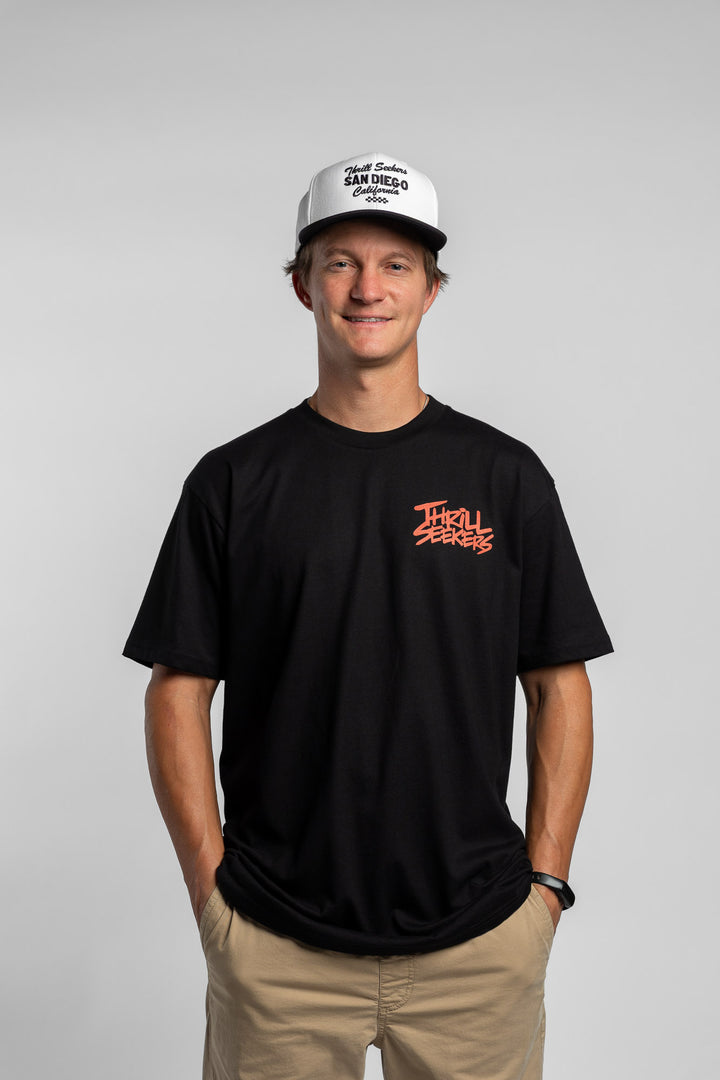 Person wearing a black tee with a 'Thrill Seekers' logo in cardinal red