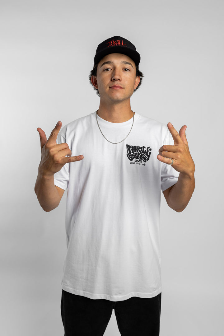 Person wearing a white t-shirt with black 'Thrill Seekers' smokin' logo