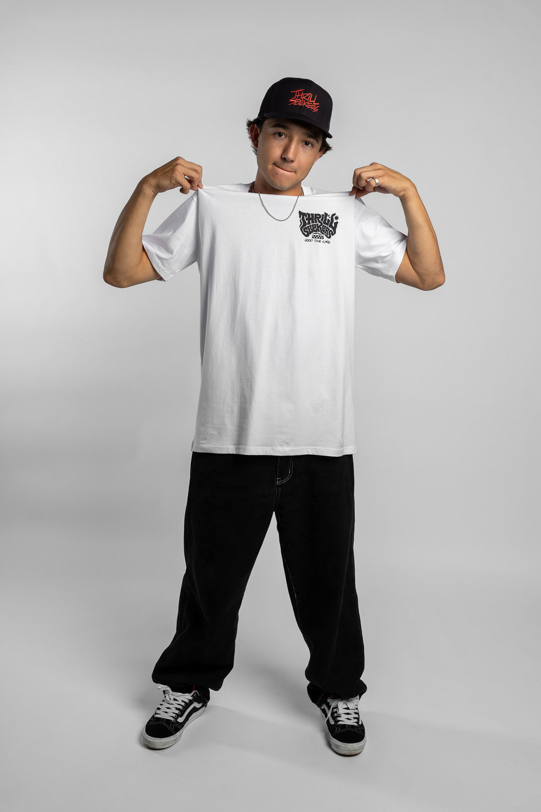 Person wearing a white t-shirt with black 'Thrill Seekers' smokin' logo