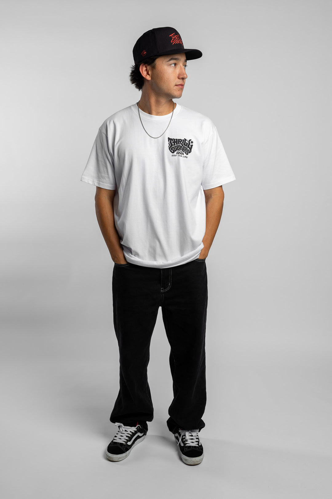 Person wearing a white t-shirt with black 'Thrill Seekers' smokin' logo