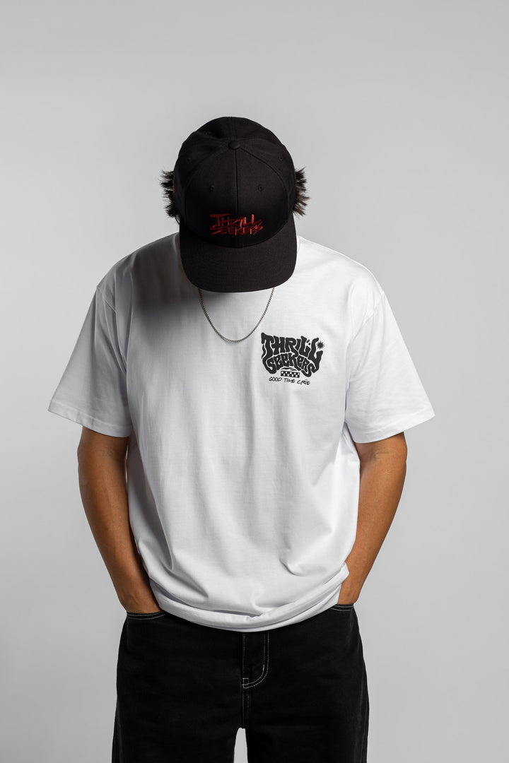 Person wearing a white t-shirt with black 'Thrill Seekers' smokin' logo