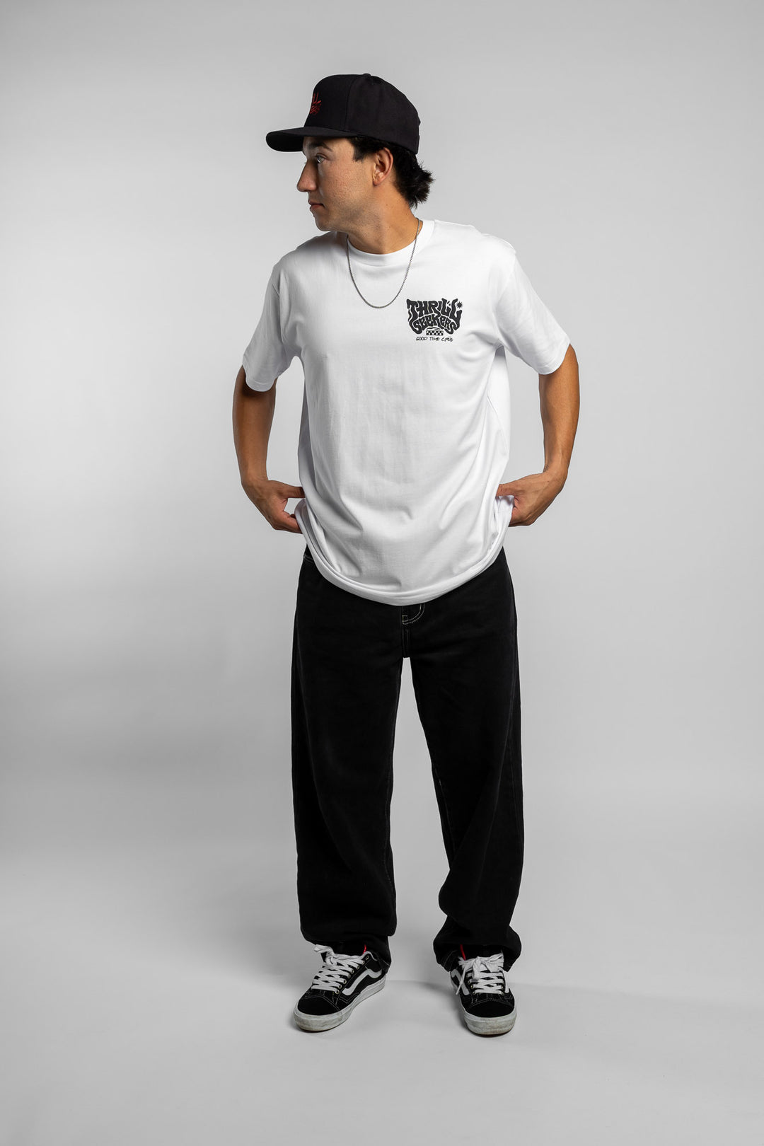 Person wearing a white t-shirt with black 'Thrill Seekers' smokin' logo