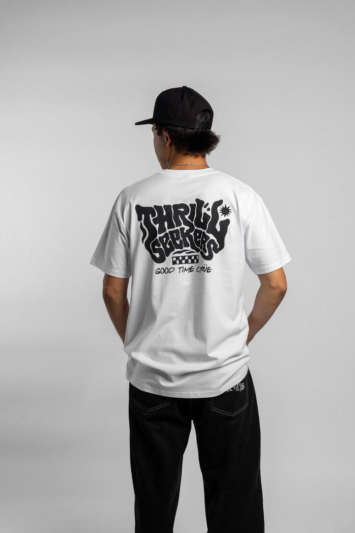 Person wearing a white t-shirt with black 'Thrill Seekers' smokin' logo