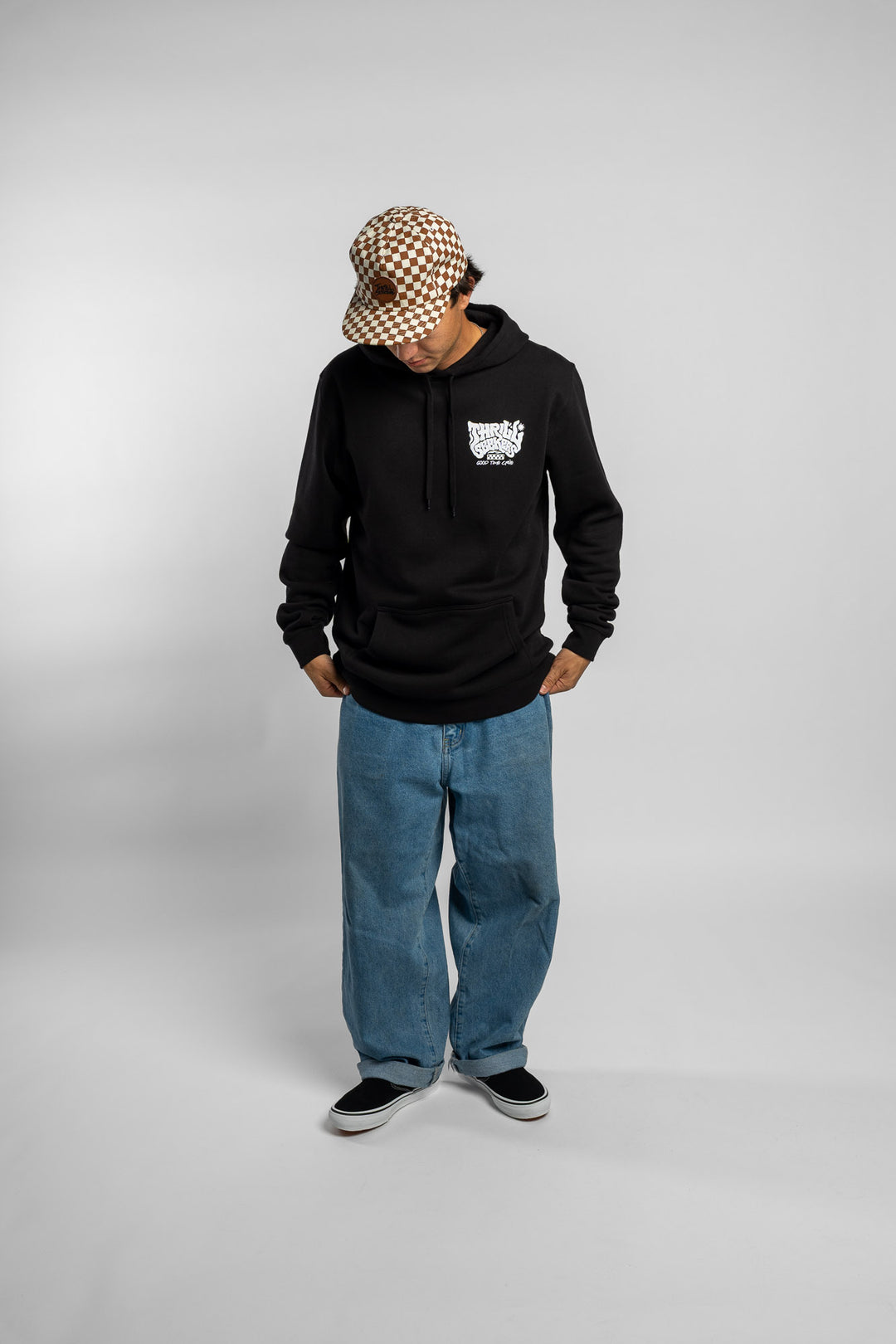 Person wearing a black hoodie with a 'Thrill Seekers' smokin' logo in white