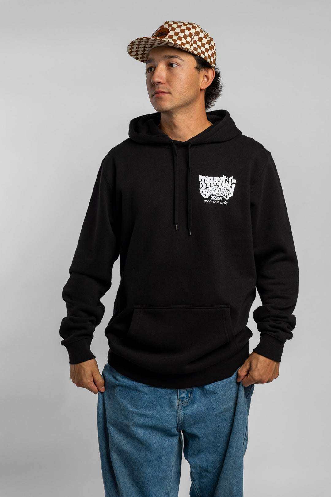 Person wearing a black hoodie with a 'Thrill Seekers' smokin' logo in white