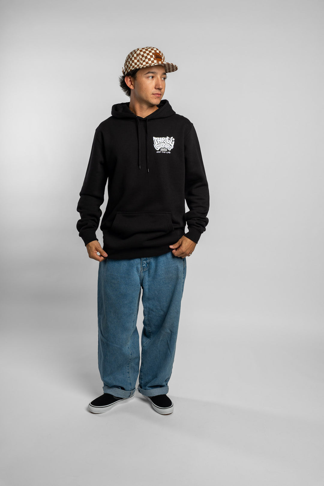 Person wearing a black hoodie with a 'Thrill Seekers' smokin' logo in white