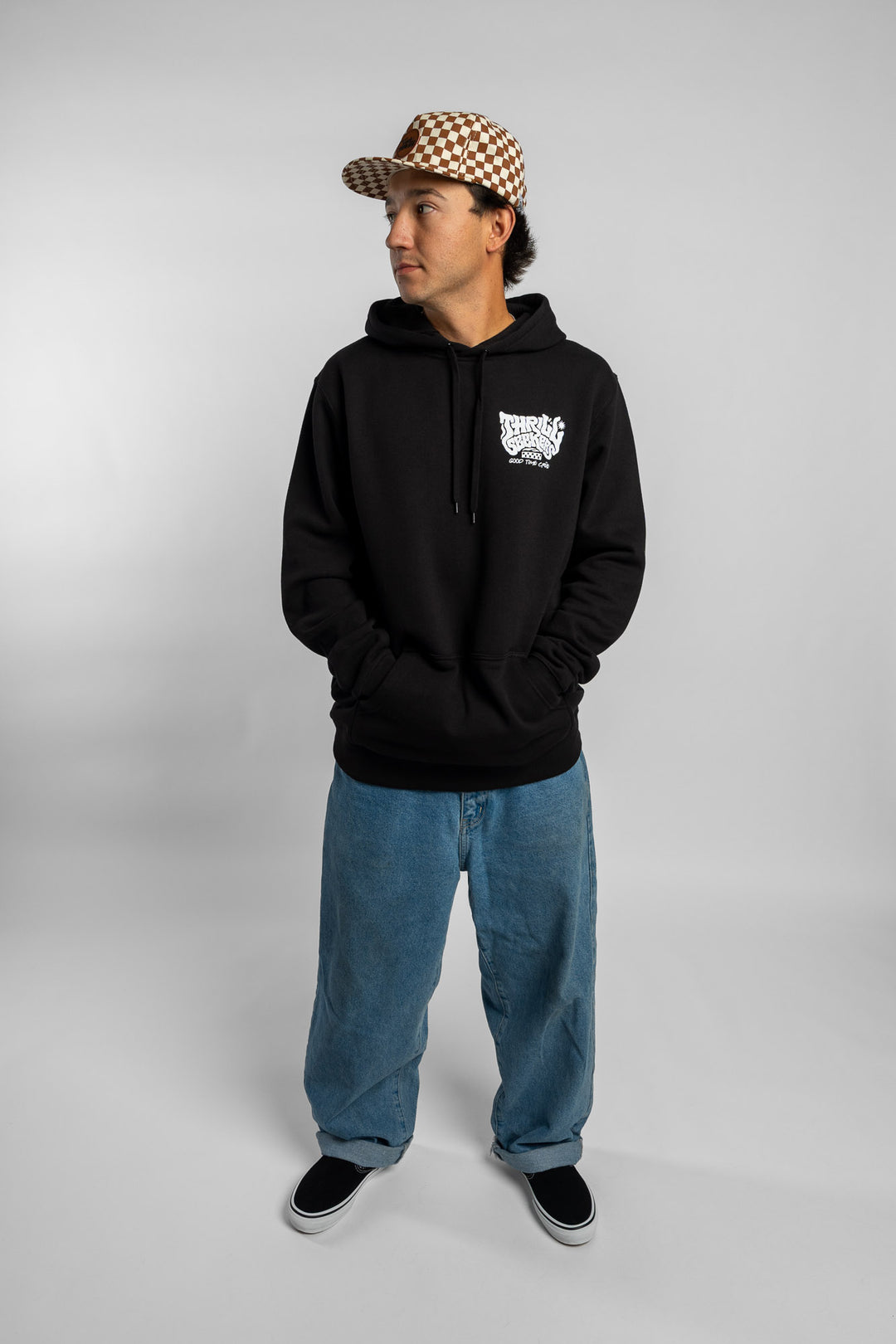 Person wearing a black hoodie with a 'Thrill Seekers' smokin' logo in white