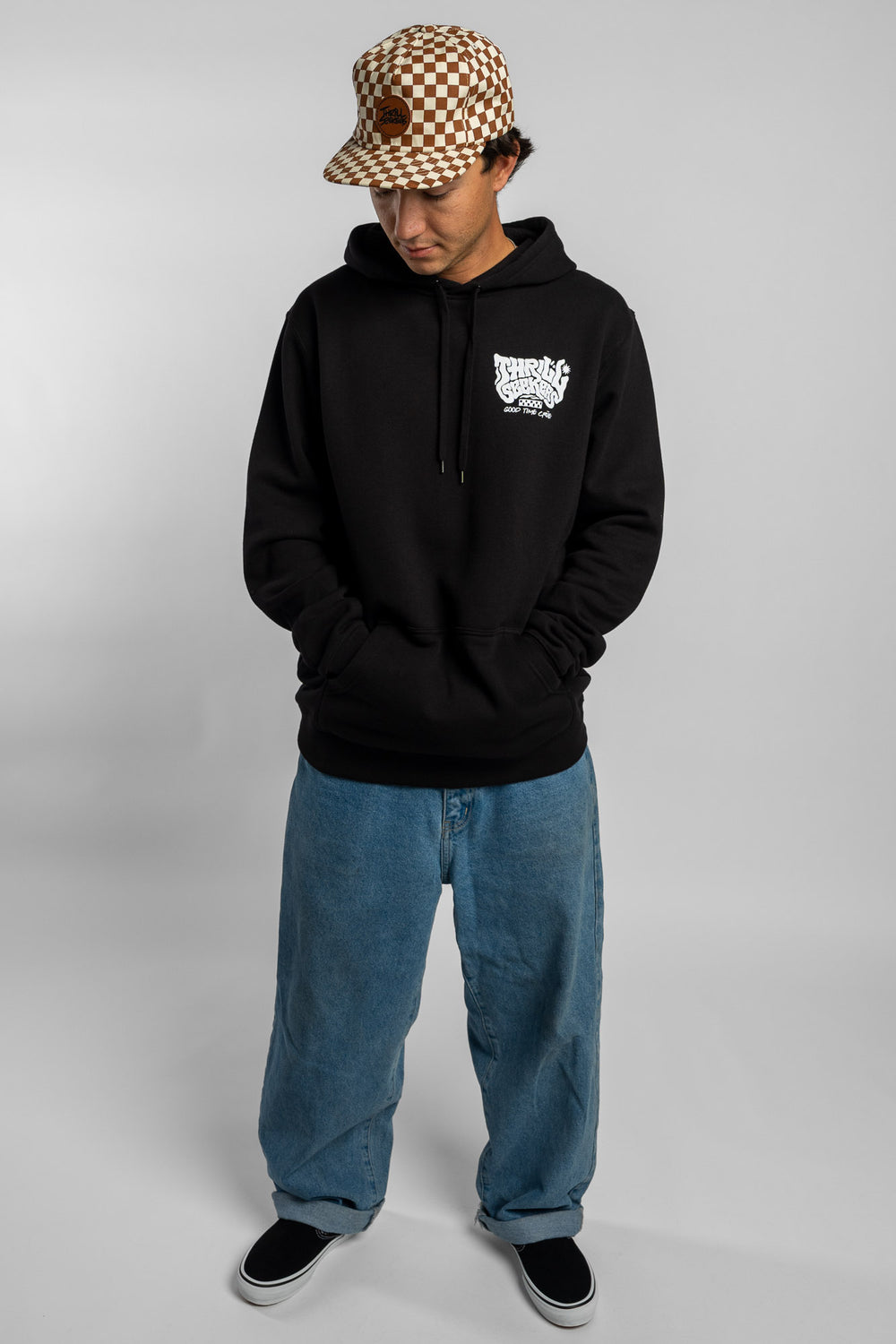 Person wearing a black hoodie with a 'Thrill Seekers' smokin' logo in white