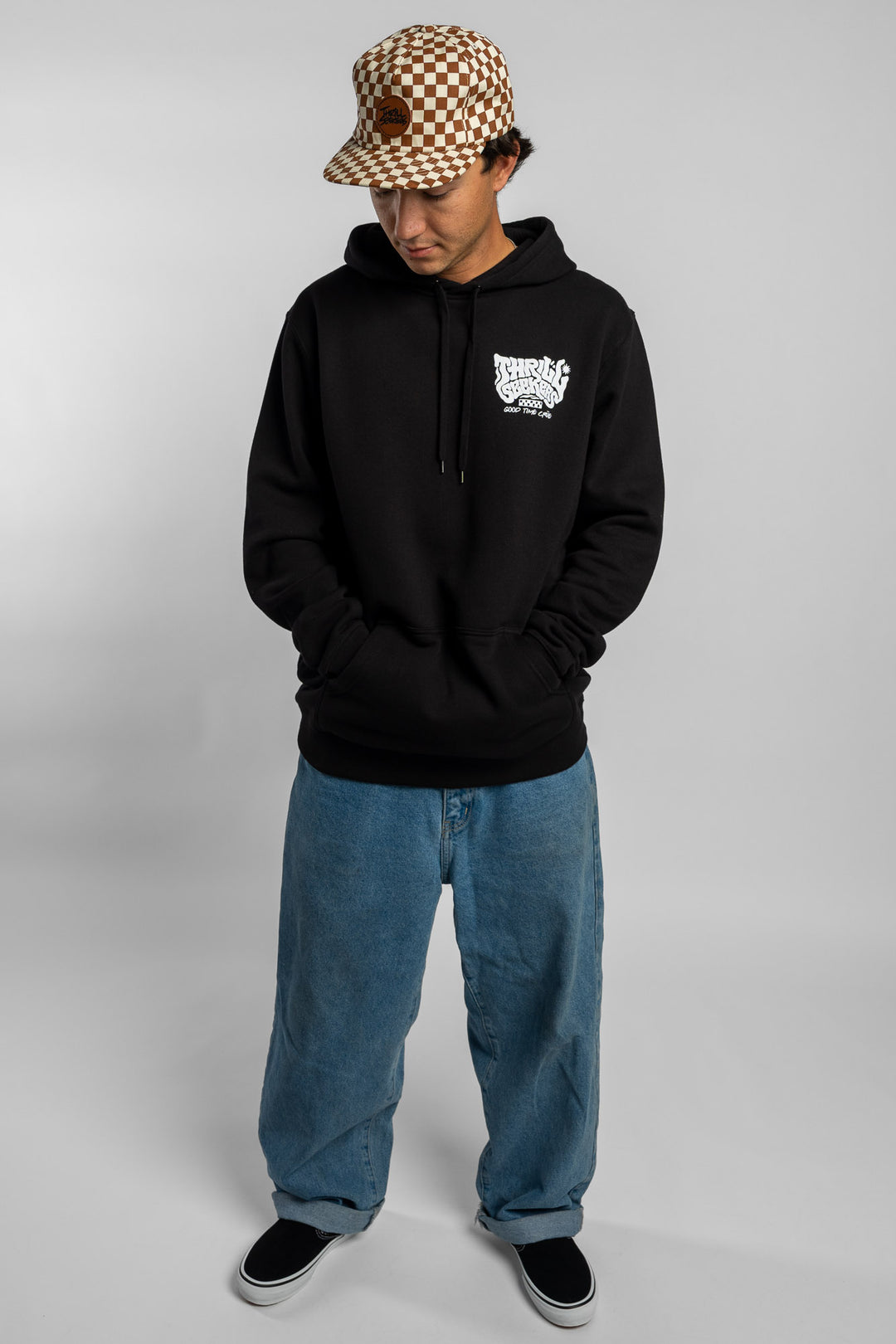 Person wearing a black hoodie with a 'Thrill Seekers' smokin' logo in white