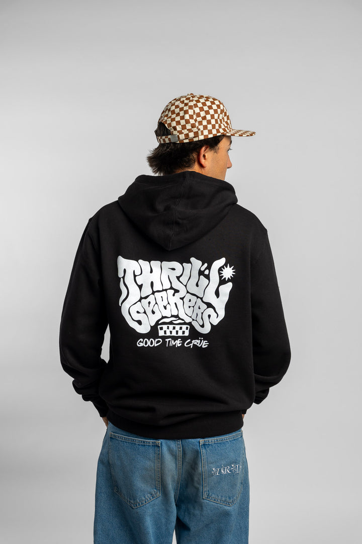 Person wearing a black hoodie with a 'Thrill Seekers' smokin' logo in white