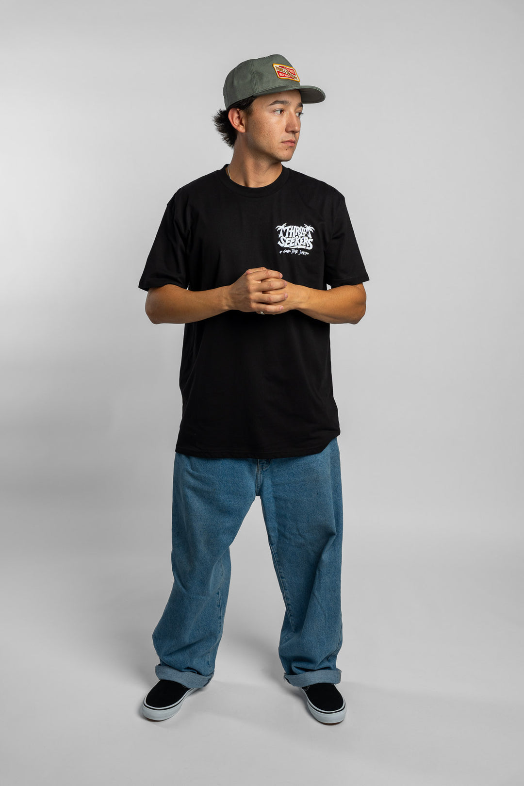 Person wearing black tee with 'Thrill Seekers' good time supply logo in white