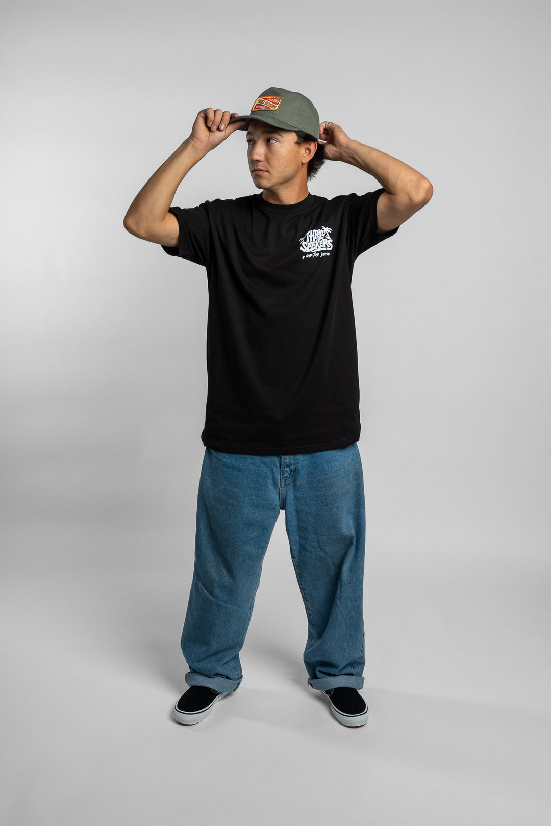 Person wearing black tee with 'Thrill Seekers' good time supply logo in white