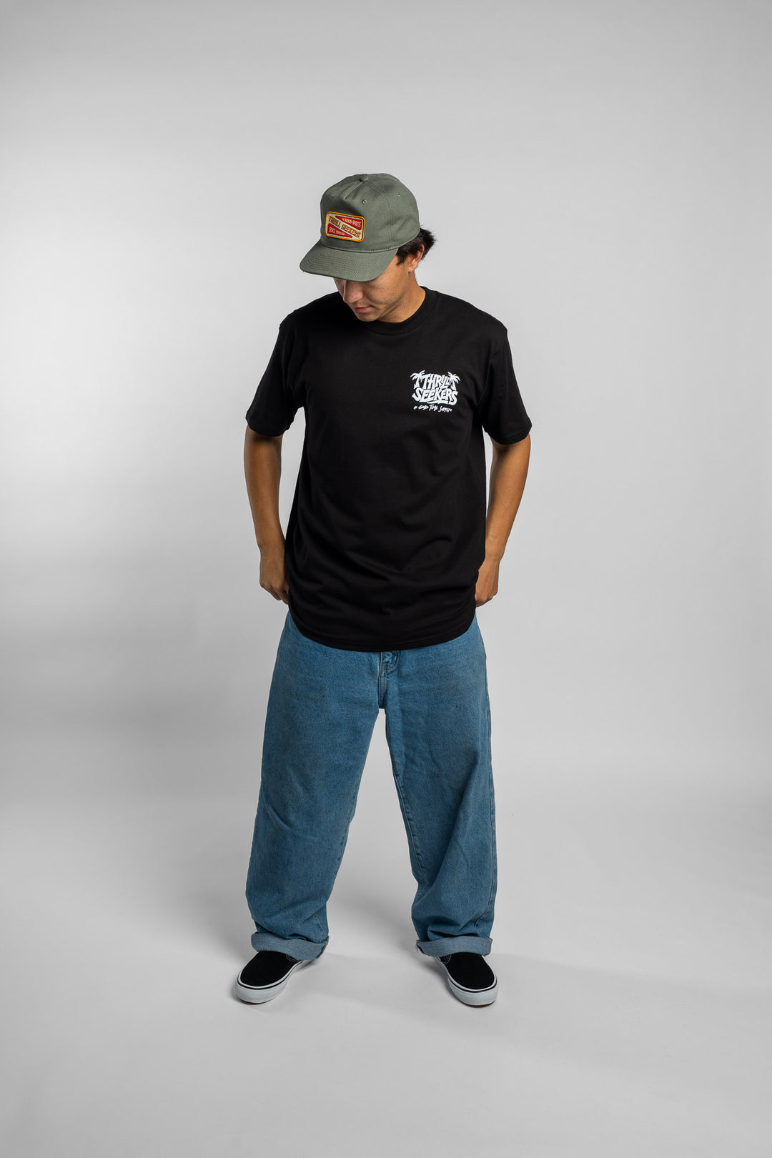 Person wearing black tee with 'Thrill Seekers' good time supply logo in white