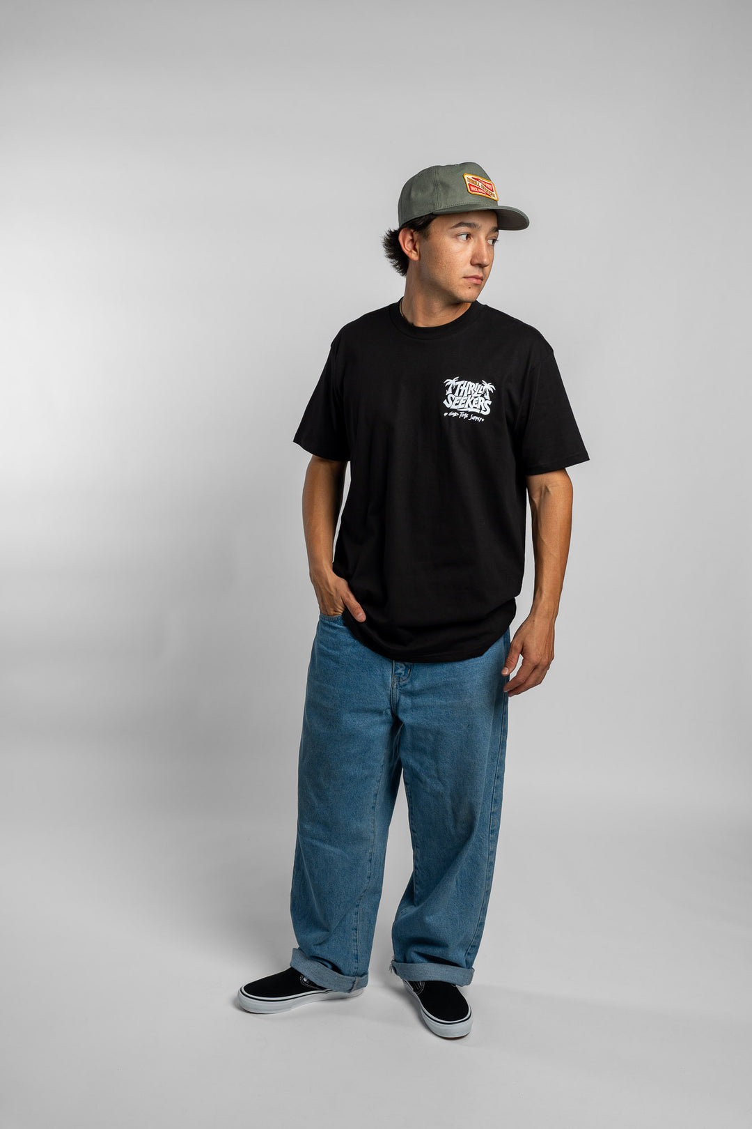 Person wearing black tee with 'Thrill Seekers' good time supply logo in white